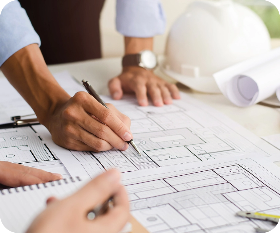 Construction professionals planning building layout — skilled talent in architecture and engineering roles across MENA
